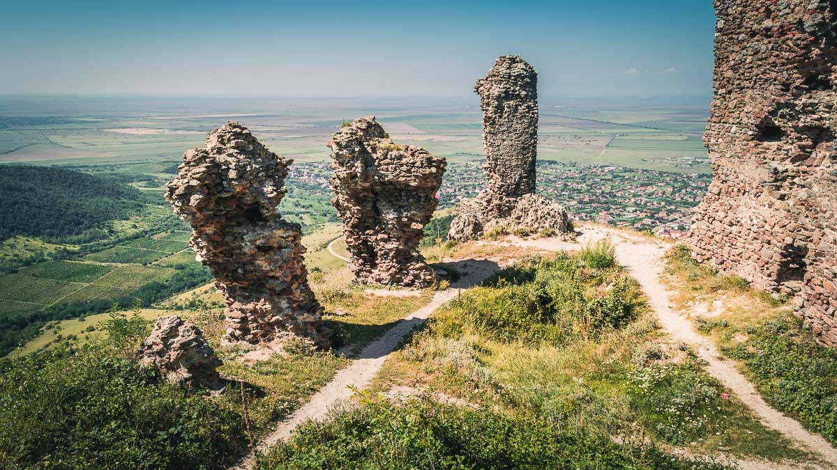 Ruins belonging to the fortress with large agricultural fields in the background.