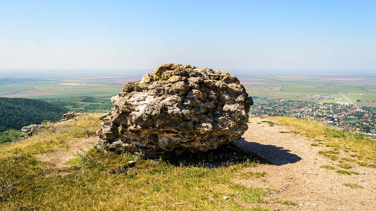 Large round shaped wall part with the commune of Șiria in the background.