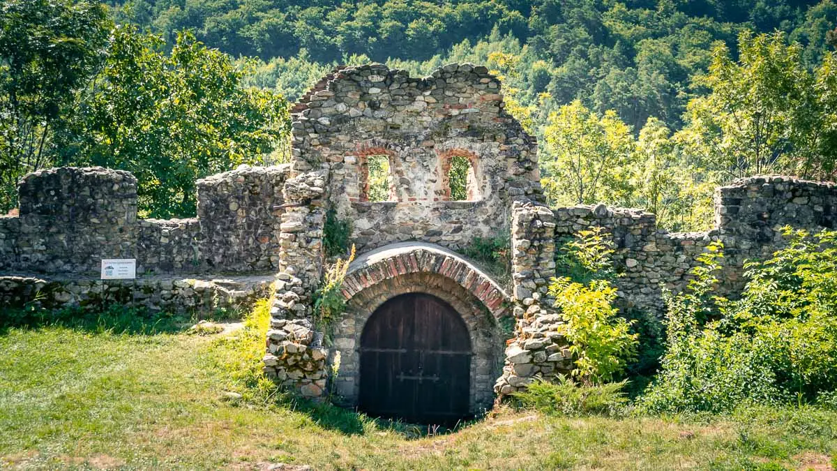 The fortified walls and a large wooden door.