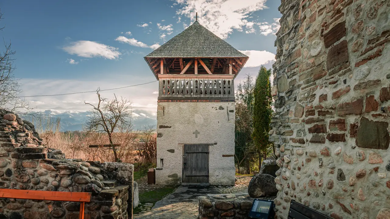 Small tower next to the stone church.