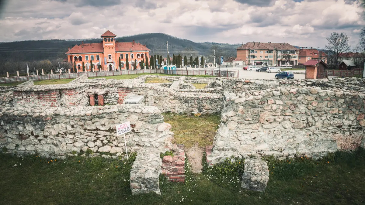 Ruins with the parking lot in the background.