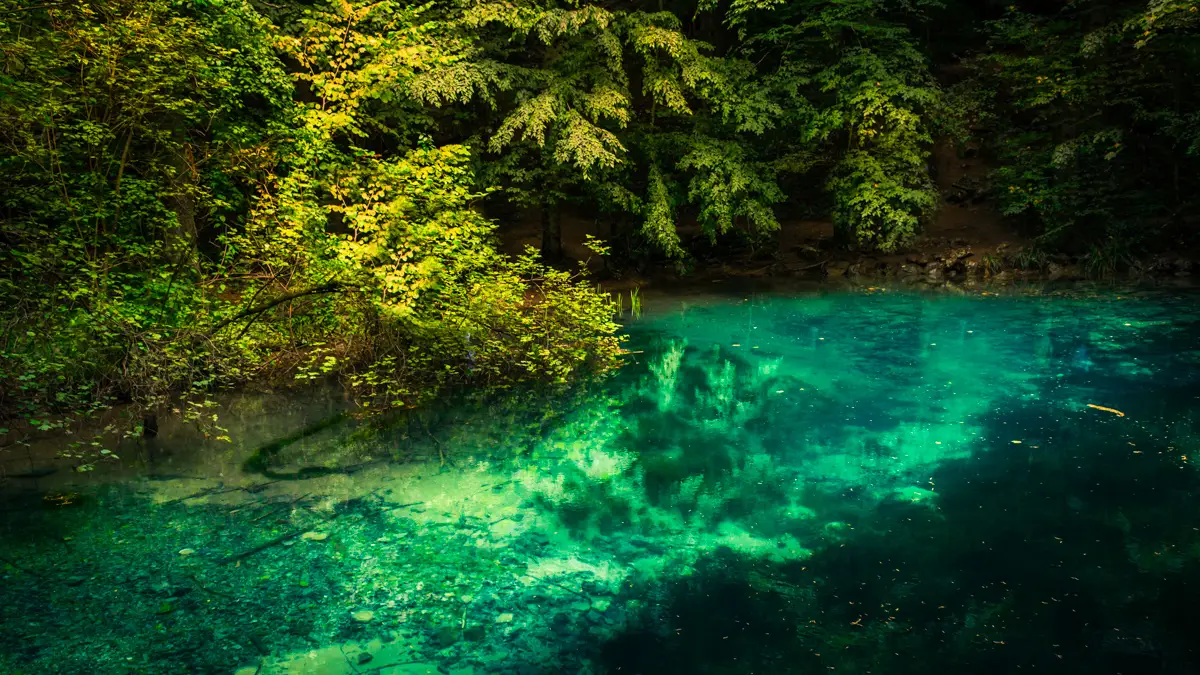 Ochiul Beiului with its turquoise water.